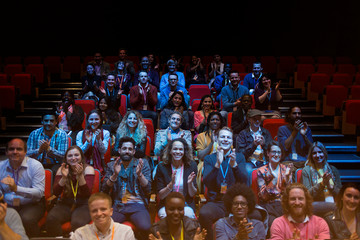 Smiling audience clapping