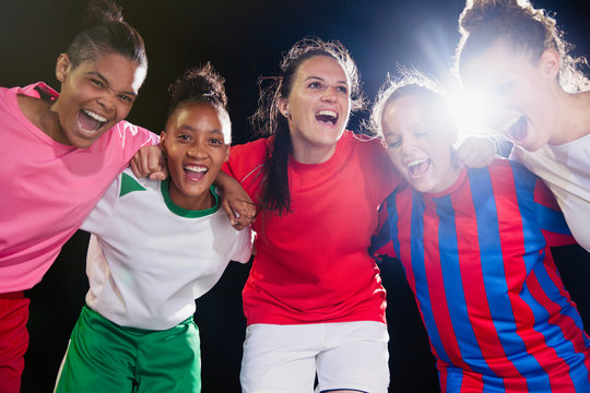 Portrait enthusiastic, confident young female soccer team bonding cheering in huddle