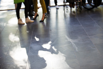 Shadow of business people on slate floor