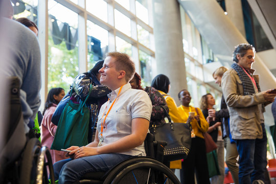 Smiling woman in wheelchair at conference