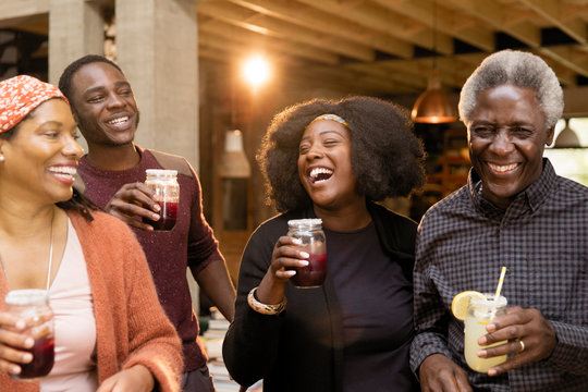 Happy multi-generation family drinking lemonade and sangria