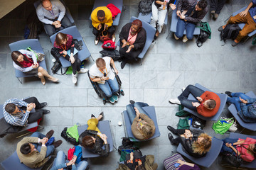 Overhead view conference audience listening to speaker in wheelchair