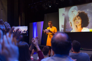 Audience clapping for female speaker