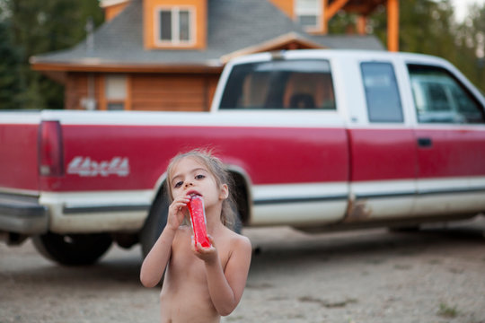 Portrait bare chested girl drinking juice near pickup trick