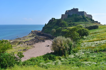 Fototapeta na wymiar View of Mont Orgueil castle and the east coast of Jersey The fortress protected the isle against French invasion Explore network of staircases and secret rooms to discover hidden treasures and artwork