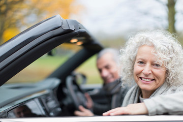 Portrait smiling senior couple in convertible