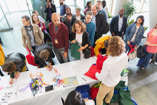 Business people checking in at conference registration table