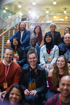 Attentive, smiling conference audience listening
