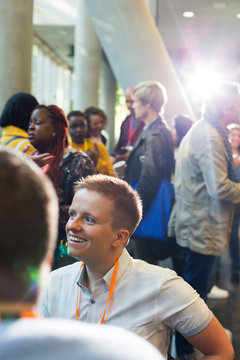 Smiling woman networking at conference