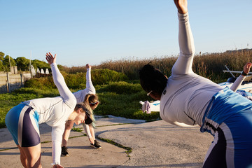 Female rowers stretching, preparing