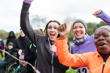 Enthusiastic female spectators cheering at charity run