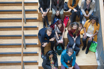 Overhead view conference audience listening with headphones