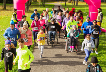 Crowd running at charity run in sunny park