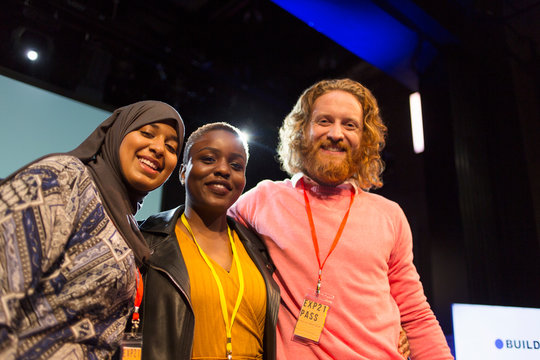 Portrait smiling conference speakers