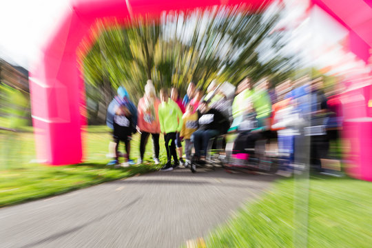 Defocused view of runners ready at charity run starting line