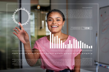 Smiling, enthusiastic businesswoman using futuristic hologram computer