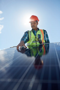 Engineer Examining Solar Panel At Sunny Power Plant