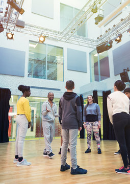 Teenage students listening to male instructor in dance class studio