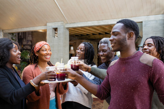 Multi-generation family enjoying sangria on patio