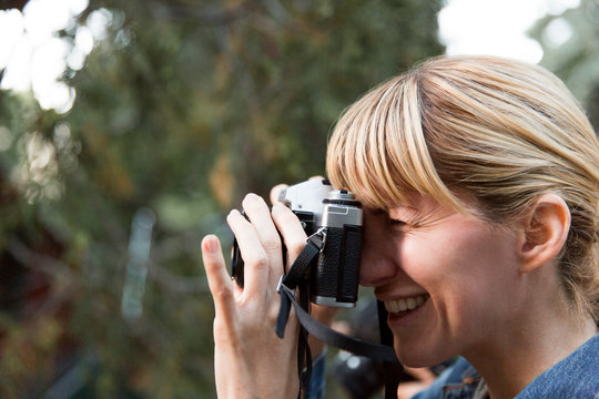Smiling woman using camera