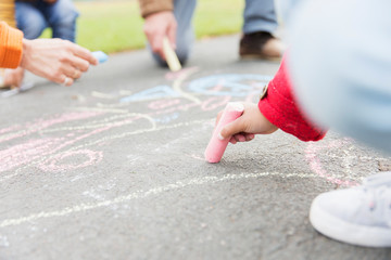 Girl drawing with sidewalk chalk