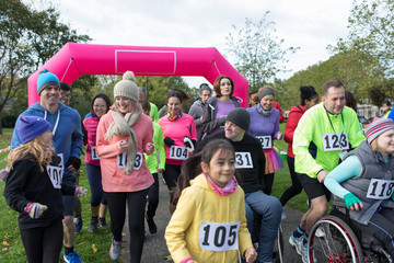 Crowd running at charity run in park