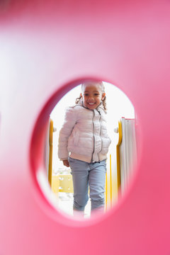 Portrait smiling girl playing at playground