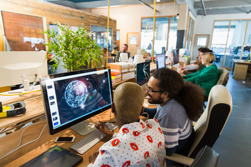 Graphic designers working in open plan office