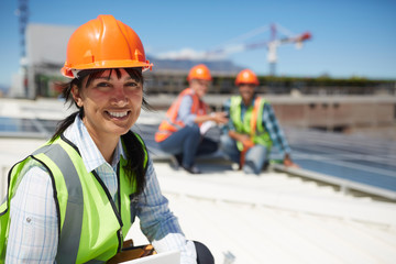 Portrait smiling, confident female engineer at sunny power plant