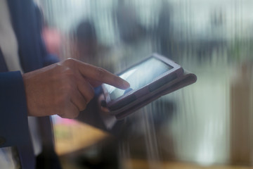 Close up businessman using digital tablet