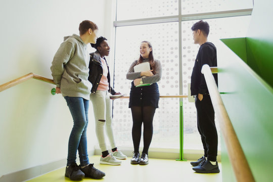 High school students talking on stair landing