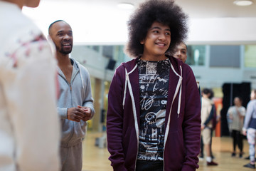 Smiling teenage boy enjoying dance class in studio