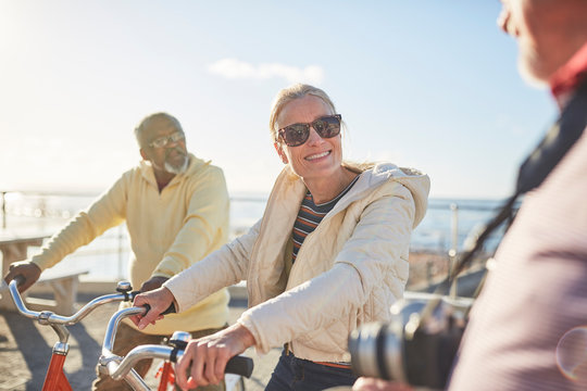 Smiling active senior tourist friends bike riding