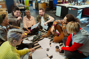 Creative business team meeting, brainstorming circle on office floor