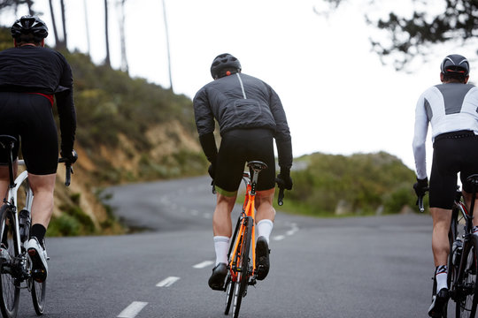 Male cyclists cycling on road
