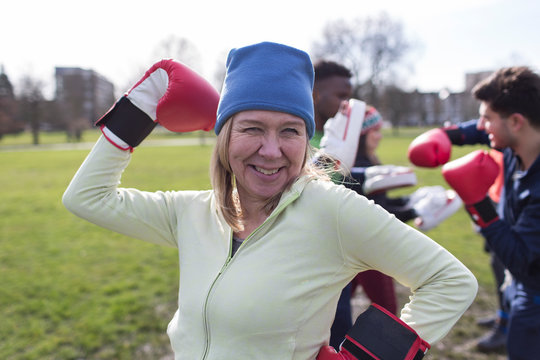 Portrait smiling, confident senior woman boxing in park