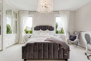 Fotobehang Hotel chique Bedroom in new luxury home with chandelier and elegant furnishings  © bmak