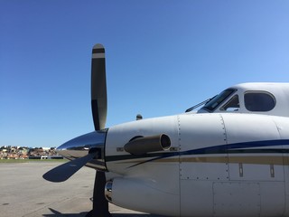 Fototapeta na wymiar Turbo propeller airplane parked in airport yard