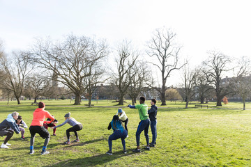 People exercising in sunny park 