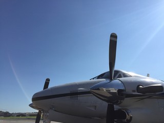 Fototapeta na wymiar Turbo propeller airplane parked in airport yard