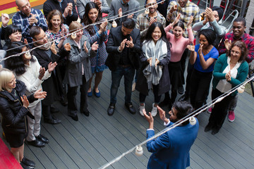 Business people clapping for businessman, celebrating on patio