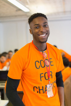 Portrait confident hacker coding for charity at hackathon