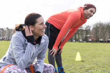 Man and woman exercising in park