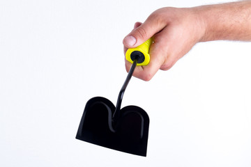 Holding black weeding hoe tool, close-up. Isolated on white background.