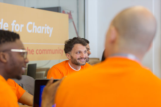 Smiling hacker coding for charity at hackathon