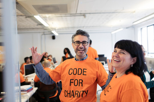 Enthusiastic hackers coding for charity at hackathon