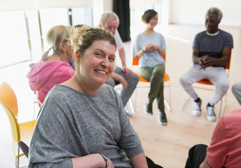 Portrait smiling instructor leading active senior exercise class