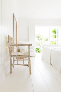 Simple Wood Armchair In White Beach House Bedroom