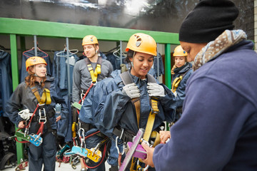 Friends preparing zip line equipment