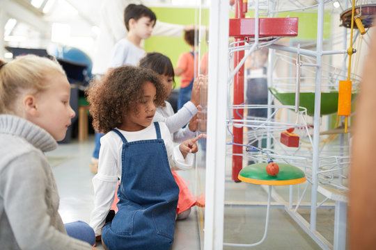 Curious kids watching exhibit in science center
